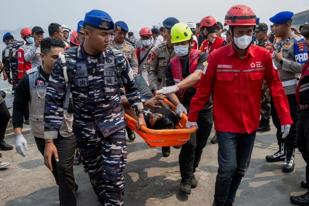 Indonesia begins operation to right capsized ship in Java Sea as 129 remain missing