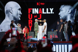 Fury and Joshua are mostly smiles as they take stage together ahead of Cardiff bout