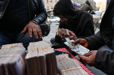 In Syria, lira under pressure, dollars kept outside banks