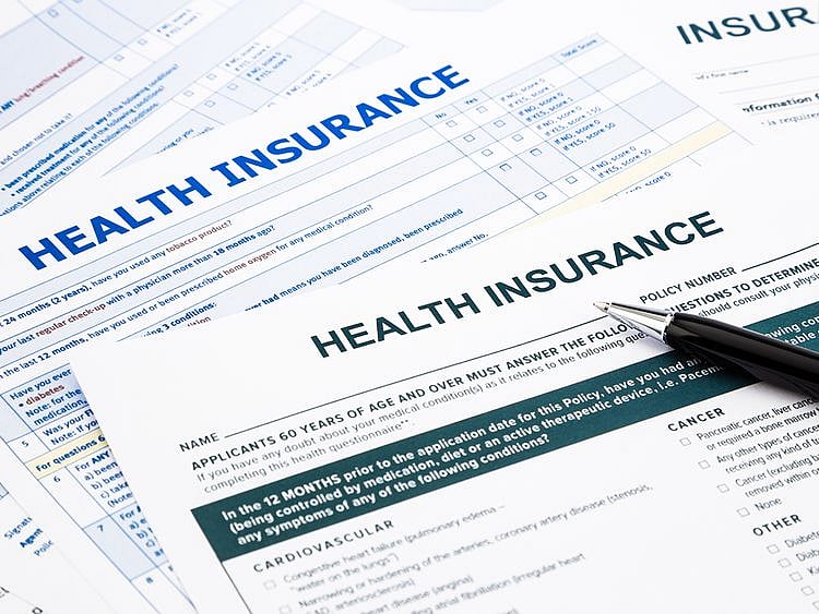 Who is responsible for health insurance in the UAE?
